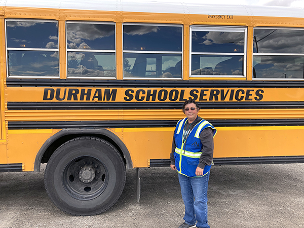 photo of molly in front of a yellow school bus