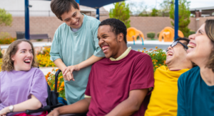 Group of employees with disabilities outside laughing together.